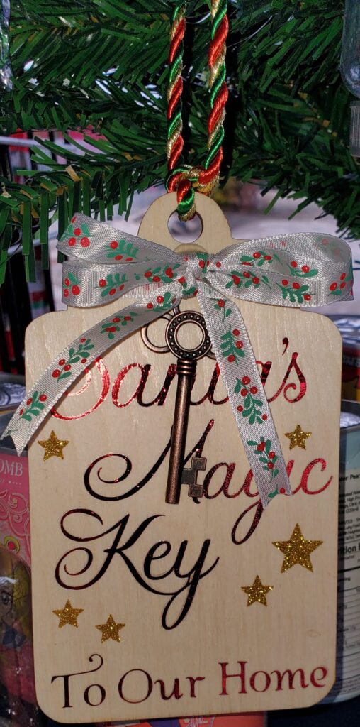 Santa’s Magic Key ornament hanging on a Christmas tree