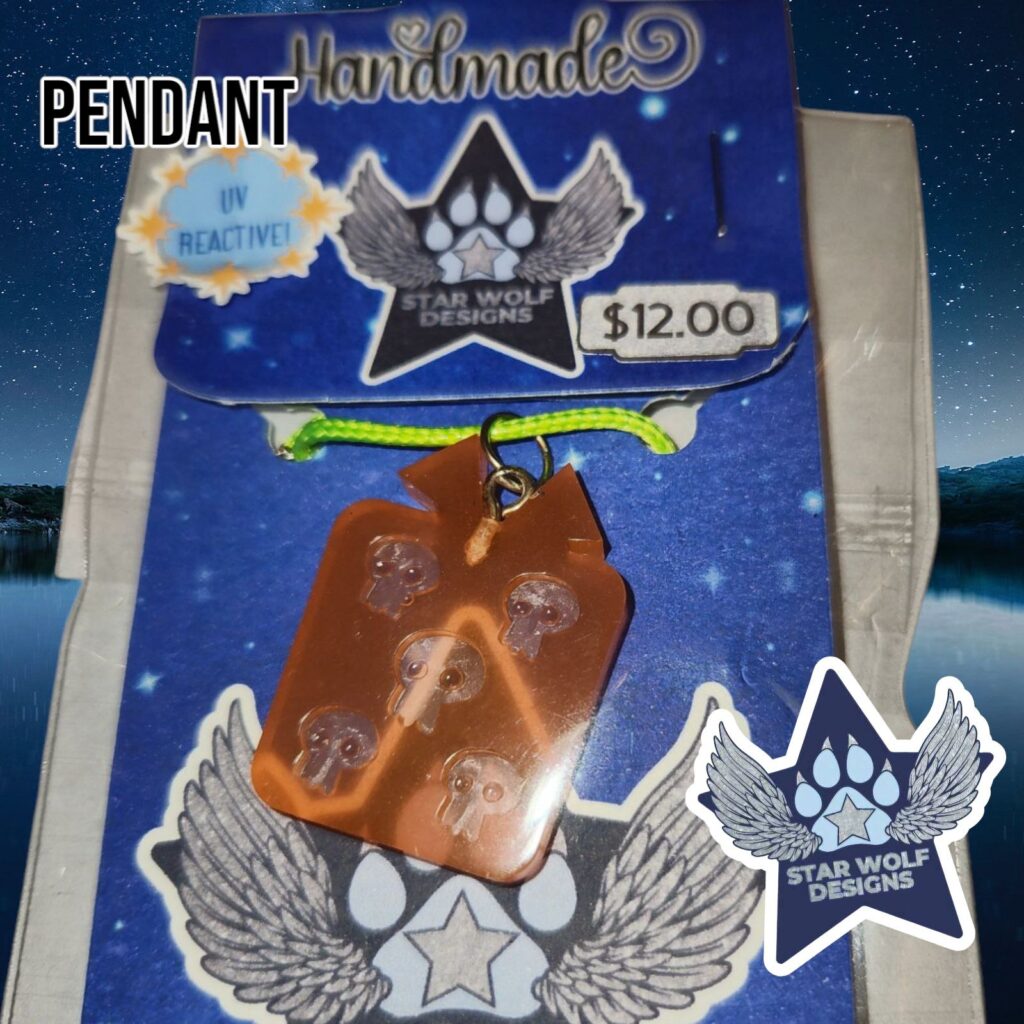 Orange resin pendant on a Star Wolf Designs card