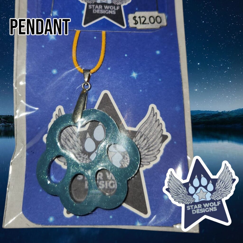 Teal paw print pendant on a Star Wolf Designs card