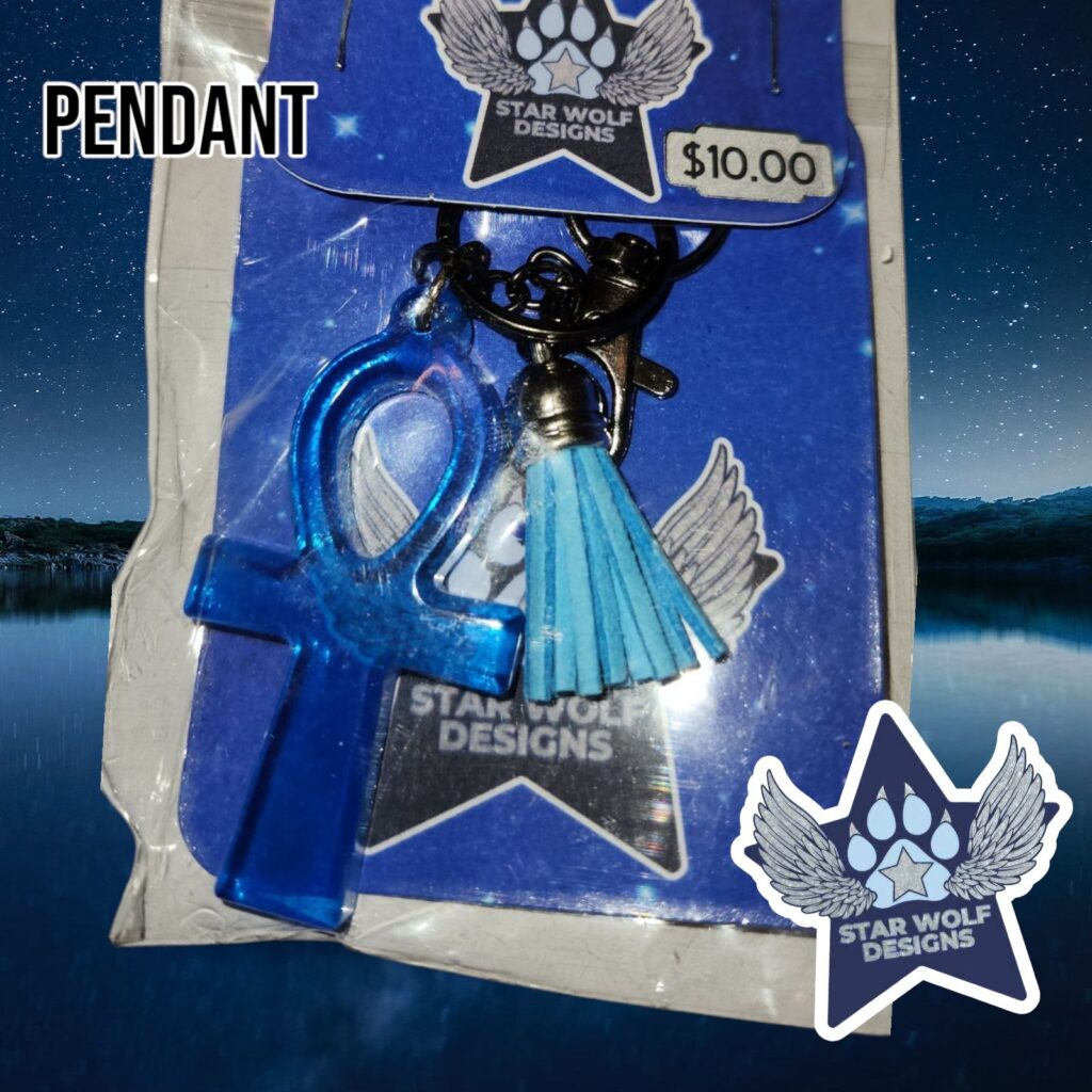 Blue pendant with a teal tassel on a Star Wolf Designs card