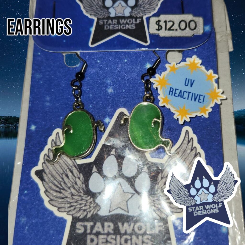 Green UV-reactive earrings on a Star Wolf Designs card