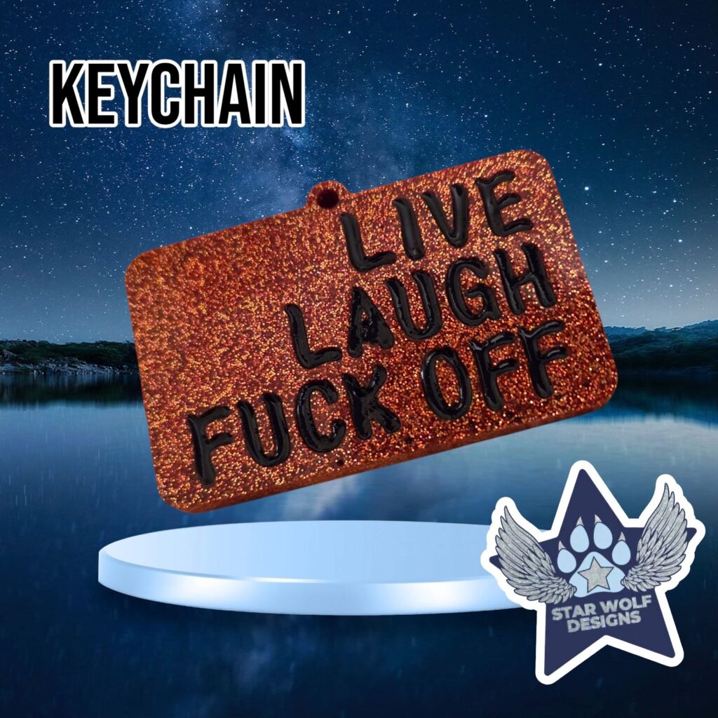 Orange glitter keychain reading “Live Laugh Fuck Off”