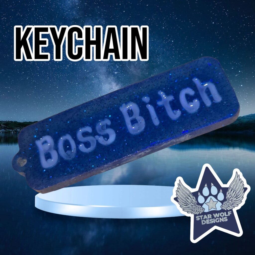 Blue glitter keychain reading “Boss Bitch”
